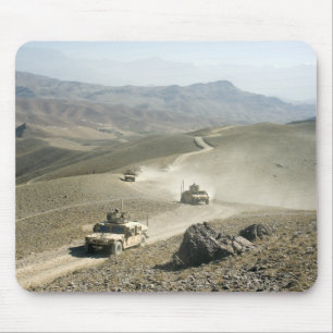 Humvees traverse rugged mountain roads mouse pad