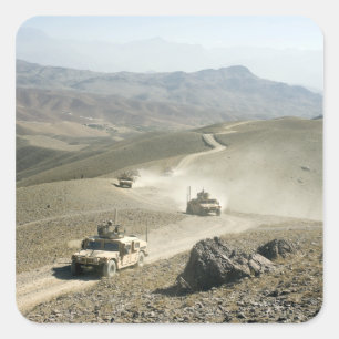 Humvees traverse rugged mountain roads square sticker