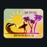 Huntington Beach California Surf City USA Magnet<br><div class="desc">Surf's up and the sun is out. A surfer, carrying their surfboard, walks away from the palm trees and towards the crashing ocean waves. Bright sunshine beams down onto the glowing California beach scene. The words Surf City USA are above the artwork and Huntington Beach, CA resides below. The colours...</div>