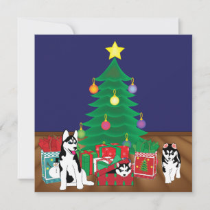 Huskies jouant sous la carte d'arbre de Noël