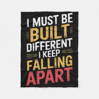 I Must Be Built Different I Keep Falling Apart  Fleece Blanket