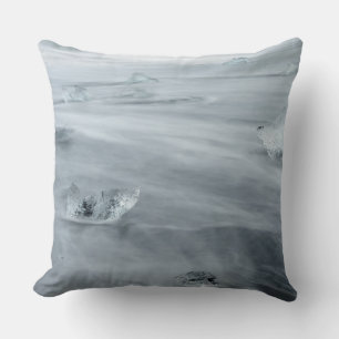 Ice and water on a beach, iceland throw pillow