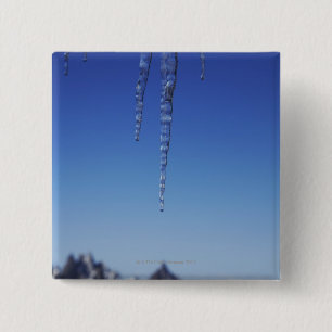 Icicles and snow-covered mountains 2 inch square button