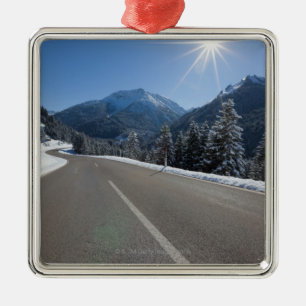 Idyllic empty road thrugh a winter landscape, metal ornament
