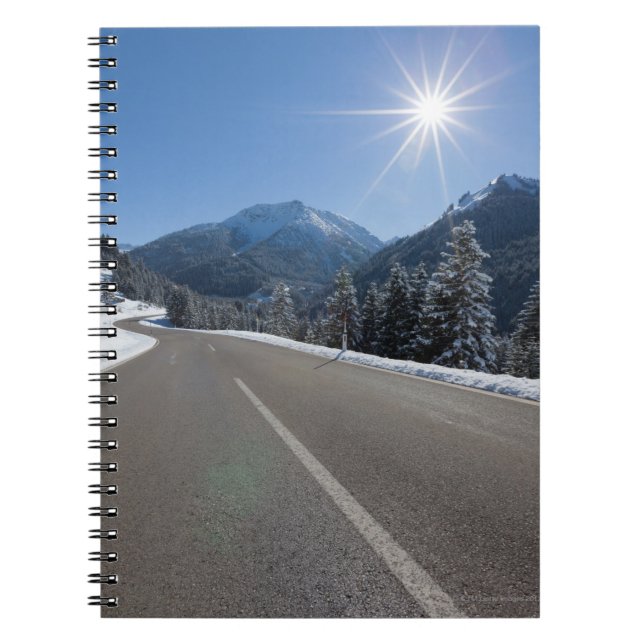 Idyllic empty road thrugh a winter landscape, notebook (Front)