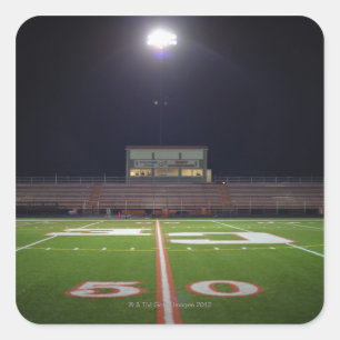Illuminated American football field at night Square Sticker