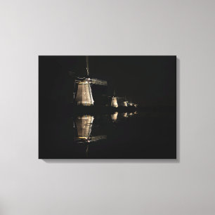 Illuminated windmills at night canvas print