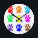 Ink Splatter Dog Paw Pattern Round Clock<br><div class="desc">A colorful pattern of dog paw prints with ink splatter effect.</div>