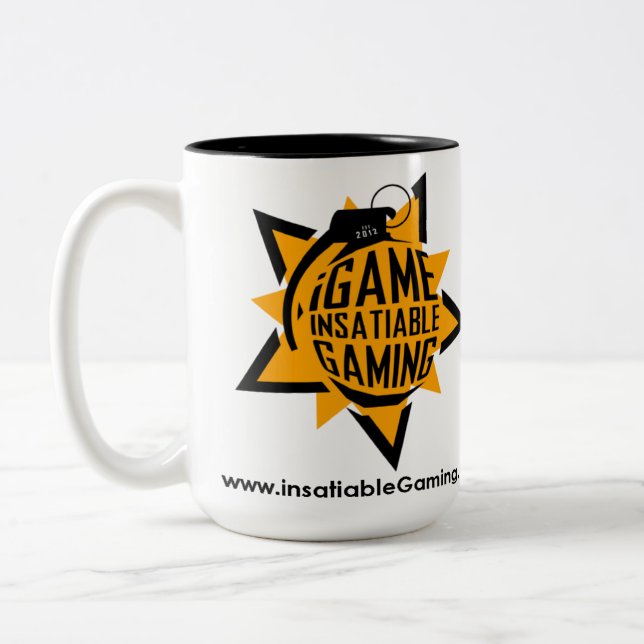 .insatiable. Jeu 15 onces. Tasse (Gauche)
