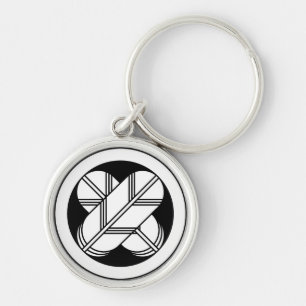 Intersecting hawk feathers in a circle keychain