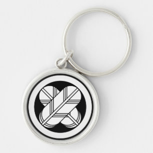 Intersecting hawk feathers in circle keychain