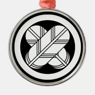 Intersecting hawk feathers in circle metal ornament