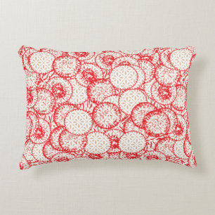Intricate textile design featuring red, gold, and  accent pillow