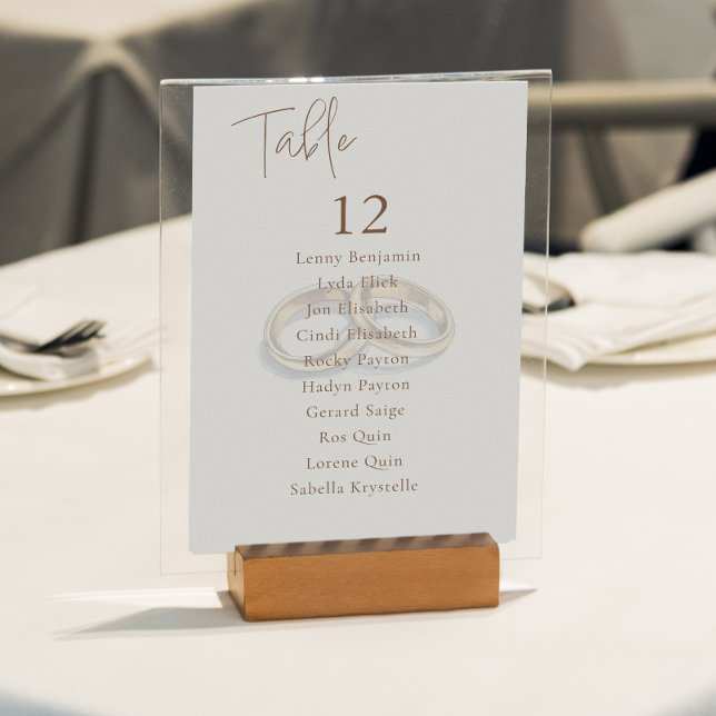 Invitation Anneaux Mariage Or Tableau Numéro de siège (Clear and elegant seating chart featuring two gold wedding rings, crisp table numbers and names.)