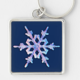 Iridescent snowflake on dark blue keychain