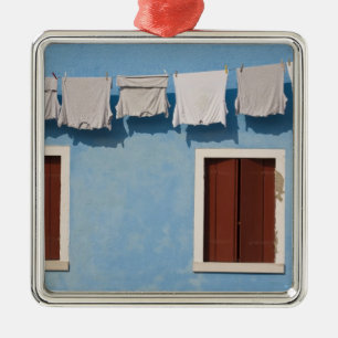 Italy, Burano. Hanging laundry and windows along Metal Ornament