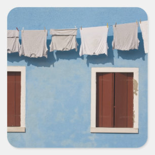 Italy, Burano. Hanging laundry and windows along Square Sticker