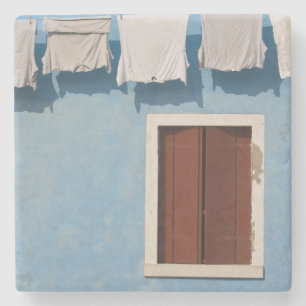Italy, Burano. Hanging laundry and windows along Stone Coaster