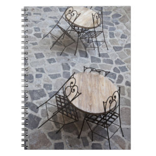 Italy, Sardinia, Castelsardo. Cafe tables. Notebook