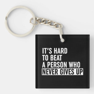 It's Hard To Beat A Person Who Never Gives Up Keychain