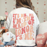 Its Me Hi Im the Maid Of Honour Its Me Personalize Sweatshirt<br><div class="desc">Introducing the "It's Me Hi I'm the Maid of Honour" Personalized Sweatshirt – a trendy and cute peach coral pink garment that adds a touch of fun and style to your Maid of Honour's wardrobe. This cool bachelorette party shirt features a front and back print with retro wavy text, making...</div>