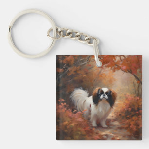 Japanese Chin dans les feuilles d'automne tombent 