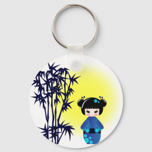 Japanese kokeshi doll at bamboo during sunrise keychain