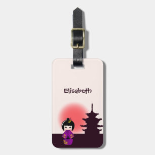 Japanese kokeshi doll at temple during sunset luggage tag