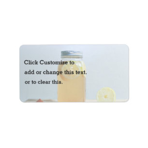 Jar with metal lid filled with lemons and water label