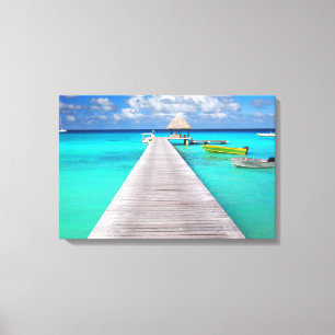 Jetty with boats in a tropical lagoon canvas print