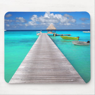 Jetty with boats in a tropical lagoon mouse pad