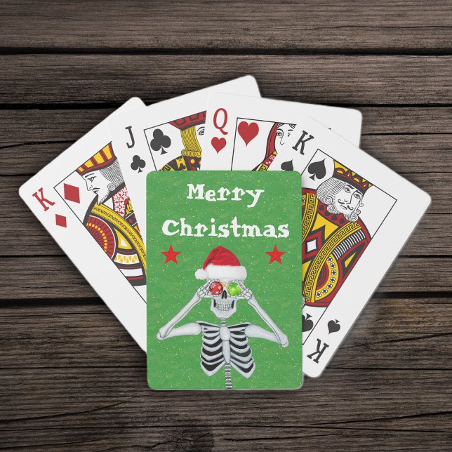 Jeu De Cartes Joyeux Noël Squelette Ornements Étoiles Santa Hat (Merry Christmas silly skeleton ornament eyes  red stars on green deck of playing cards.)