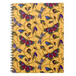 Jewellery butterflies and dragonflies on yellow notebook