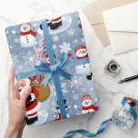 Jolly Santa Claus and Snowmen Christmas Pattern Wrapping Paper<br><div class="desc">Bring the festive cheer to your holiday decor with this delightful Christmas pattern featuring a jolly Santa Claus carrying a sack full of gifts and adorable snowmen in cozy winter scarves and hats. Set against a whimsical backdrop of snowflakes, this design captures the magic of the holiday season and adds...</div>