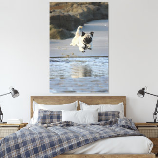 Joyful Pug Leaping by the Ocean Canvas Print