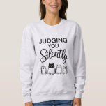 JUDGING YOU Silently Sweatshirt<br><div class="desc">Four cute cartoon cats. It blends sarcasm and charm, perfect for cat lovers with a witty side.
It's a playful way for the wearer to show off personality—sarcastic, observant, and fond of cats.
Design Note: For custom requests, message me at daed.halabi@gmail.com. 😊</div>