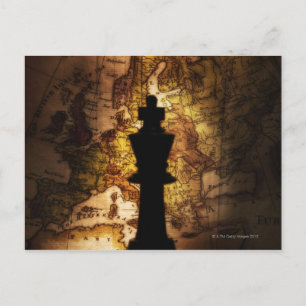 King chess piece on old world map postcard