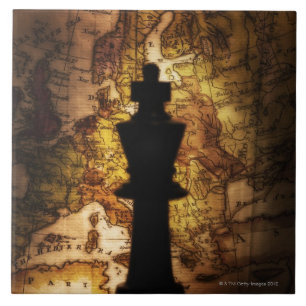 King chess piece on old world map tile