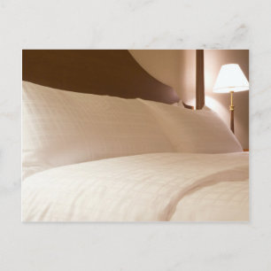 King sized bed in a hotel suite room postcard