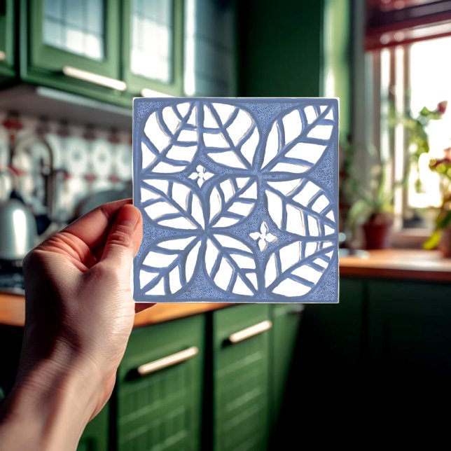 Kitchen backsplash tile, Blue and white Ceramic T Tile (Blue and white ovate leaf ceramic tile held in a hand  in front of a green kitchen.)