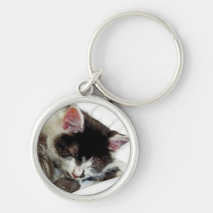 Kitten asleep on White Comforter Keychain