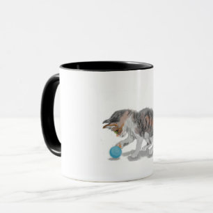 Kitten playing mug