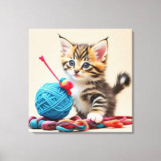 Kitten playing with a ball of thread canvas print