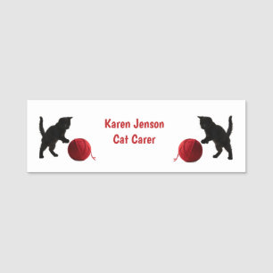 Kitty playing with red ball of wool name tag