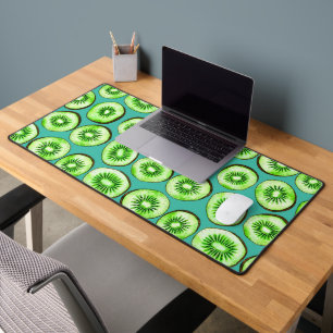 Kiwi slices on turquoise desk mat
