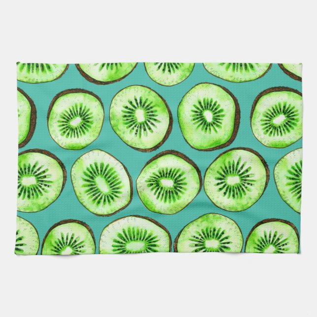 Kiwi slices on turquoise kitchen towel (Horizontal)