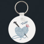 Knitting and Yarn Lovers Personalized Keychain<br><div class="desc">Personalize this keychain with your name or custom text. The design features a heart shaped ball of yarn with knitting needles and a little butterfly. The key ring has a colour palette of grey,  pink and blue. Please browse our store for matching and coordinating items.</div>