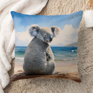 Koala on a sandy beach throw pillow