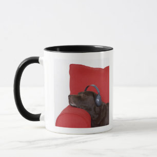 Labrador wearing headphones lying on sofa mug