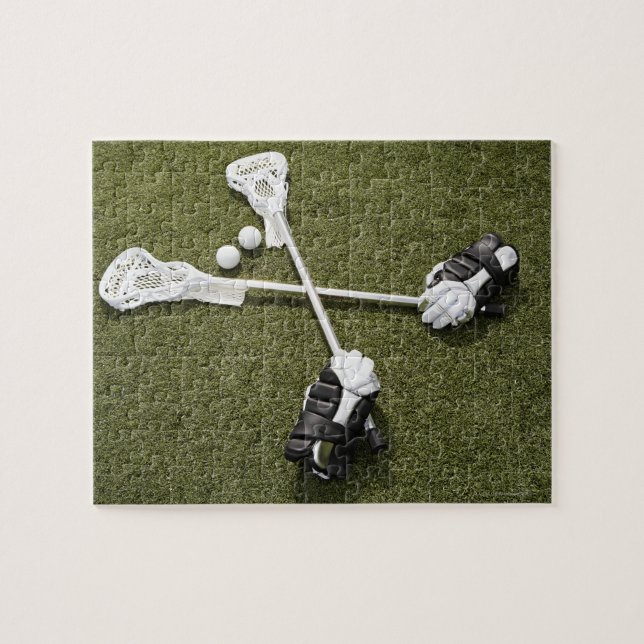 Lacrosse sticks, gloves and balls on artificial jigsaw puzzle (Horizontal)